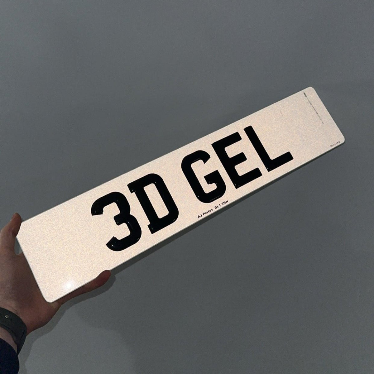 3D gel number plate under flash showing reflective road-legal finish