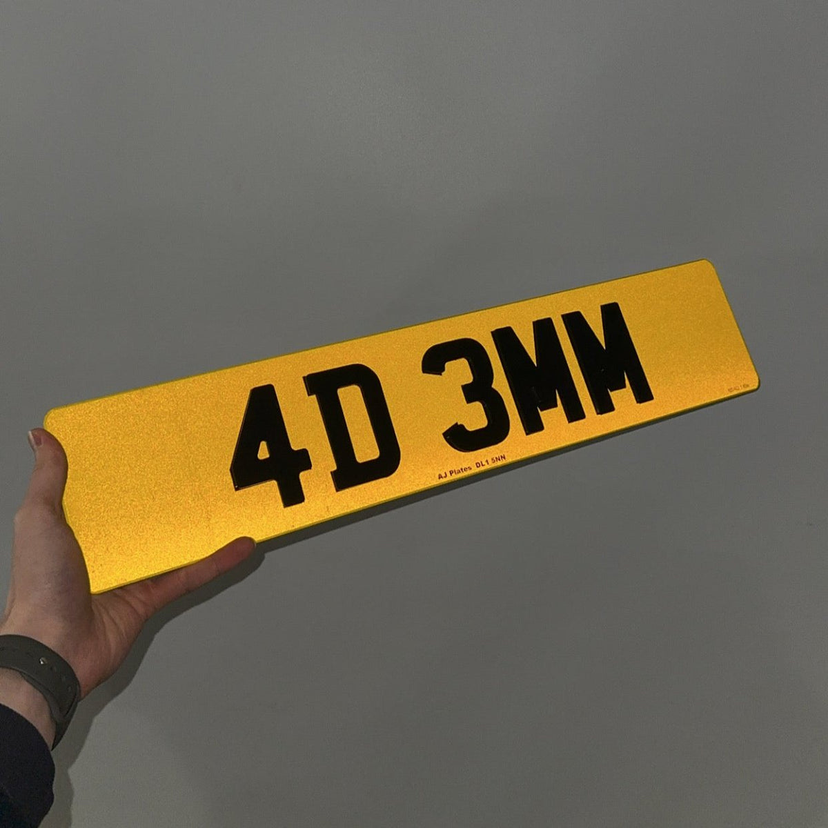 4D number plate under flash showing 3mm laser-cut characters and reflective backing